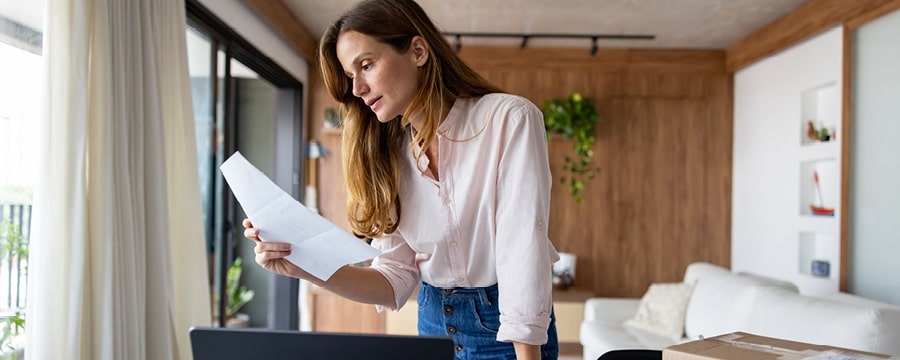 A woman holding papers in her hand